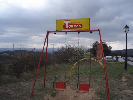 A swing set advertising "Torres" chocolate.